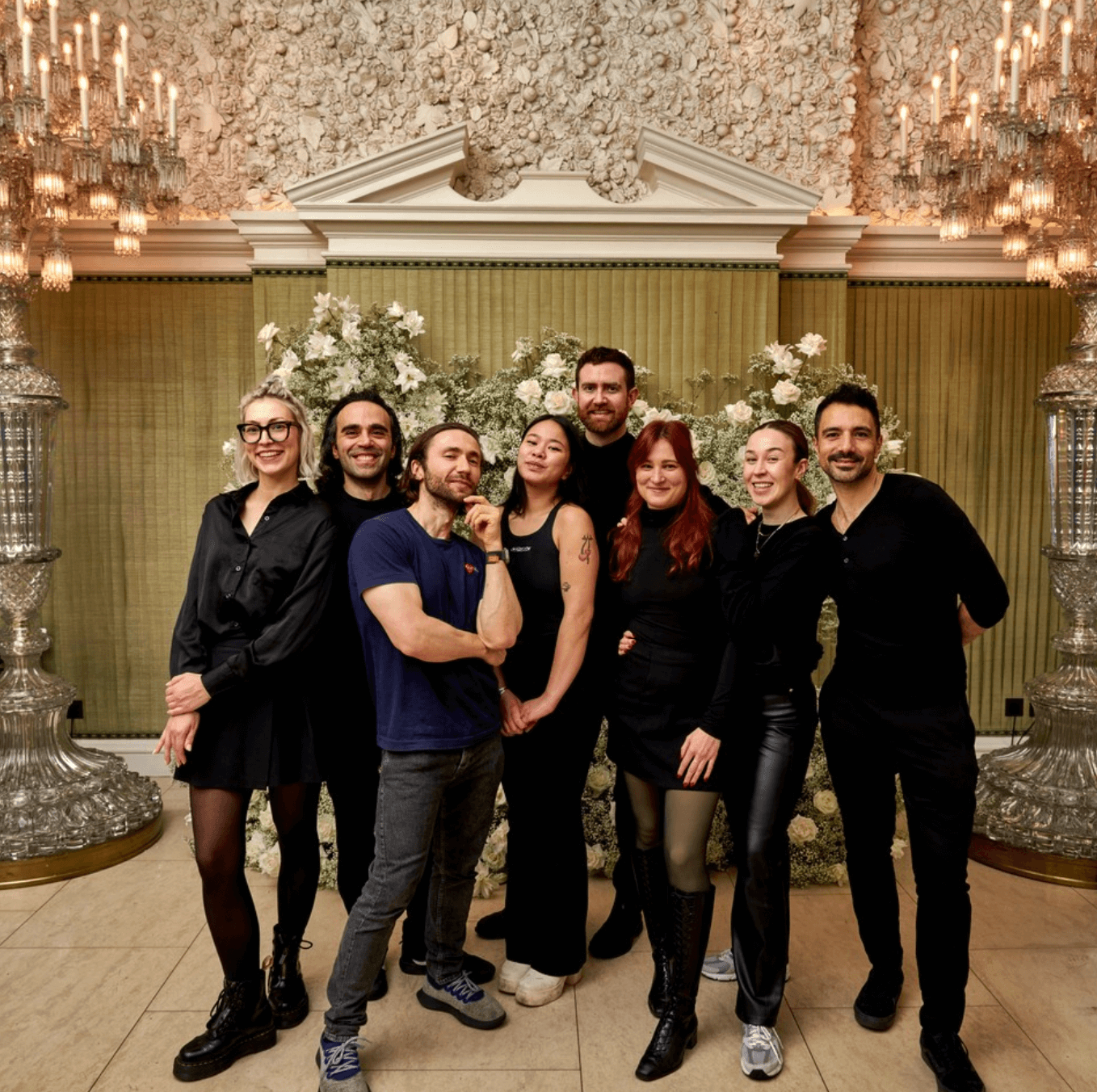 The team at blooming haus standing in front of vogue's annual fashion and film party floral designs at annabel's.