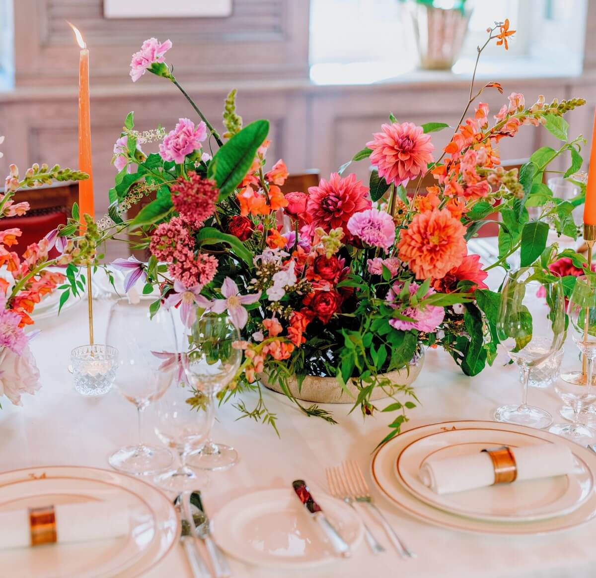 Floral centrepiece with red, pink, and orange flowers