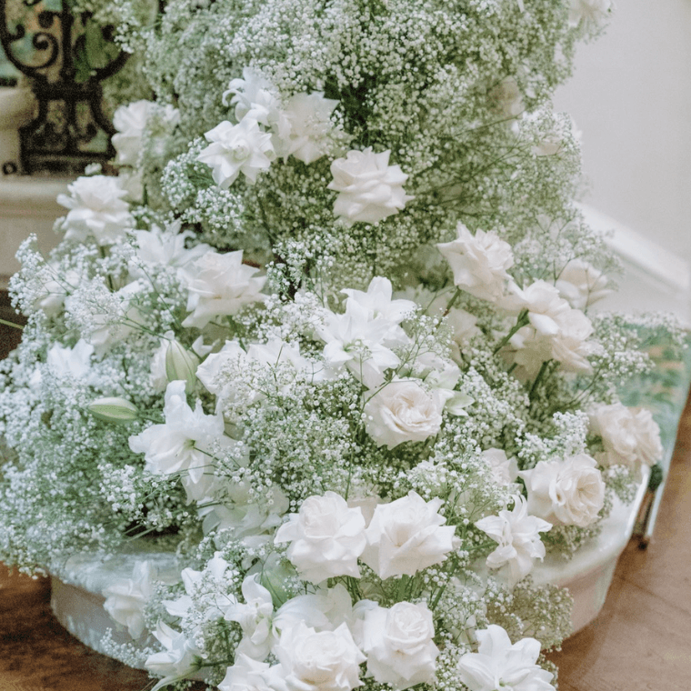 White roses, roselilies, and baby's breath