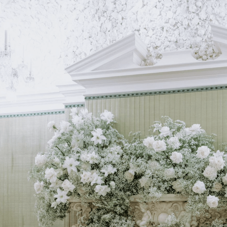 White flower on a fire surround under a cornice piece