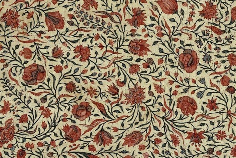 A chintz floral pattern in red and green.