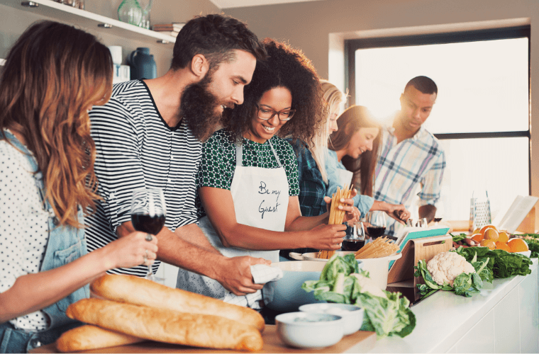 A group of male and female friends cooking
