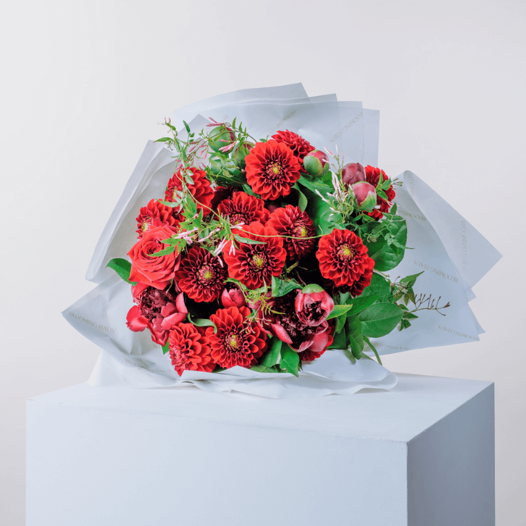 A bouquet of red dahlias and roses