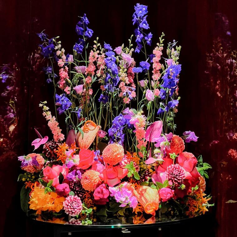 A colourful floral display by blooming haus with purple, pink, and orange blooms