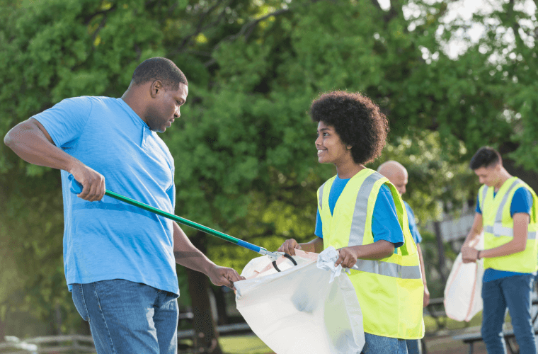 A group of people picking up litter in the community