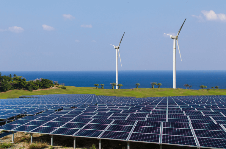 Wind turbines in the background and solar panels in the foreground