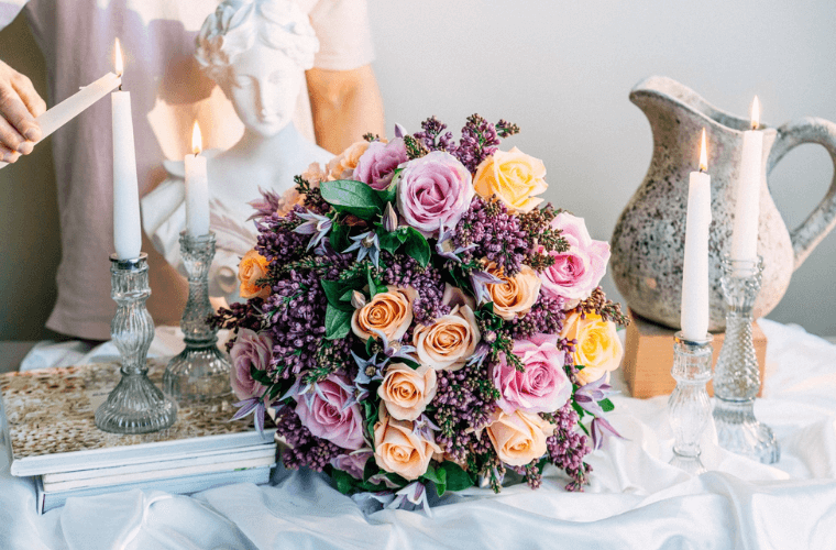 A floral display with orange, yellow, and pale pink flowers