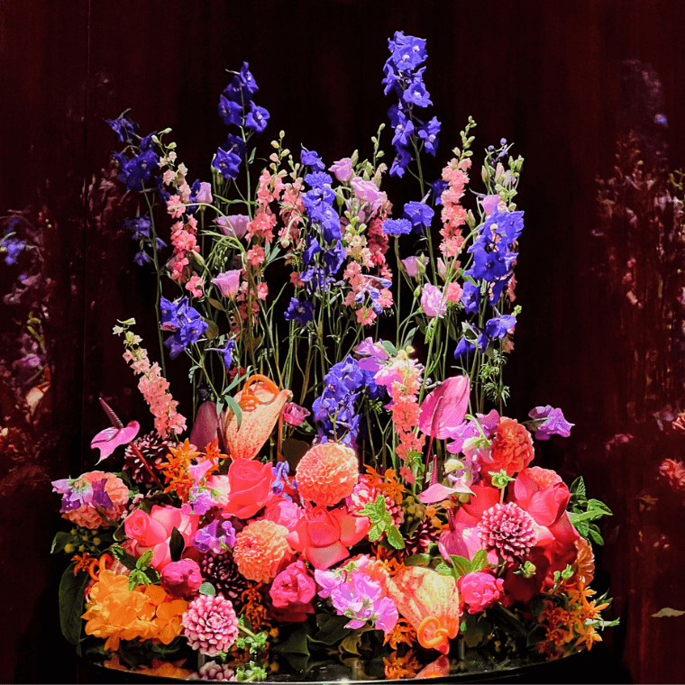 A bright floral display with orange, purple, and pink flowers