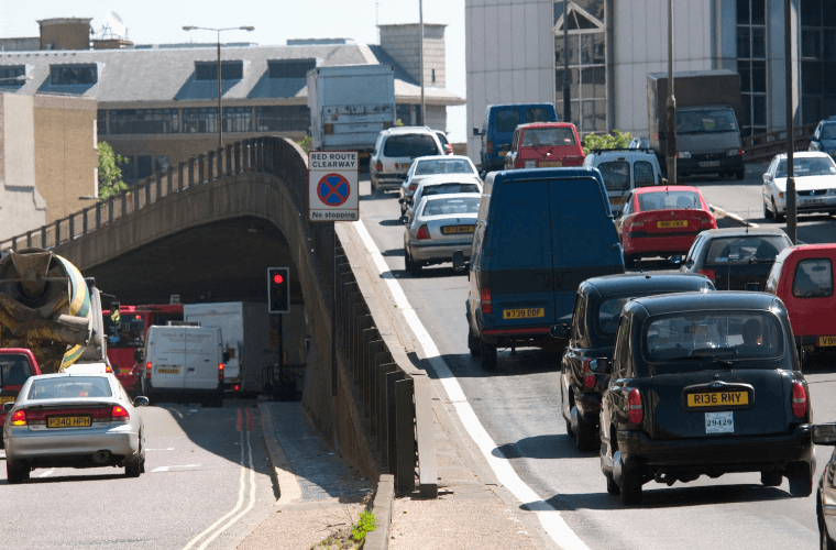 A lower london road and a flyover with heavy traffic