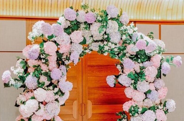 The top half of a flower arch including mock orange, hornbeam, and hydrangea leaves