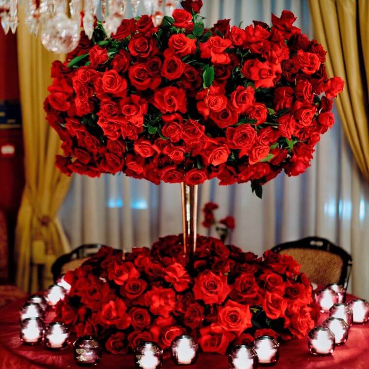 A circular two-layer flower installation featuring red roses