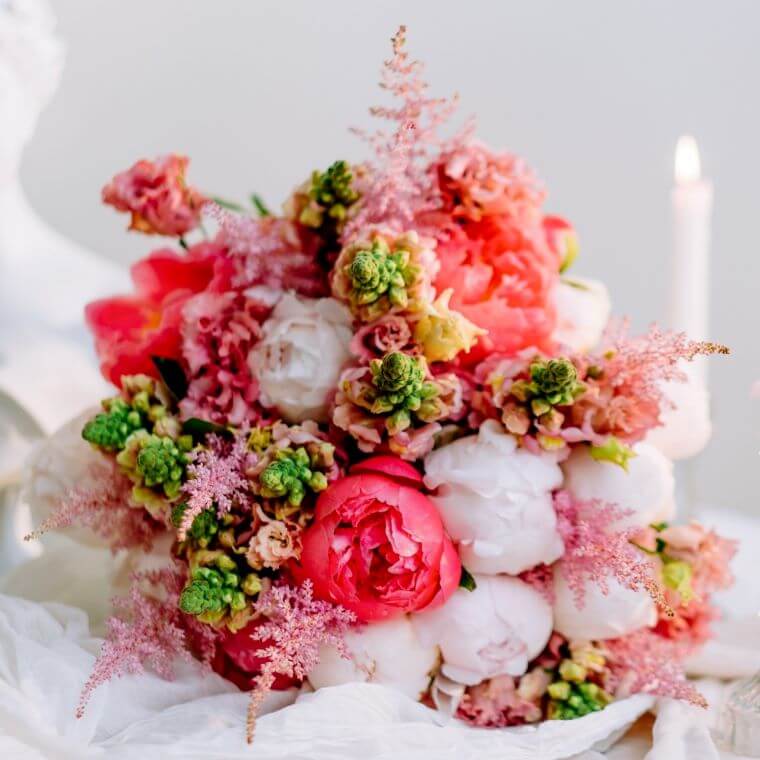 A floral display containing pink and white peonies