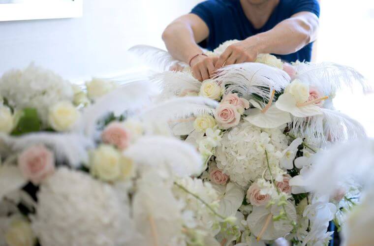 A florist putting the final touches to a wedding floral display