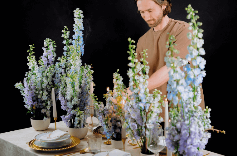Michal from blooming haus designing a tablescape with purple flowers