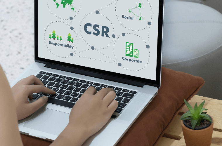 A pair of hands typing on a keyboard with csr symbols on the screen