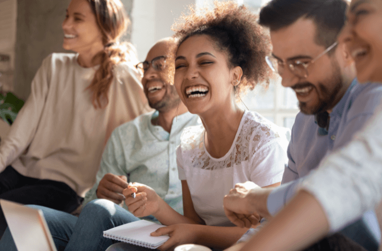 Three women and two men seated and smiling