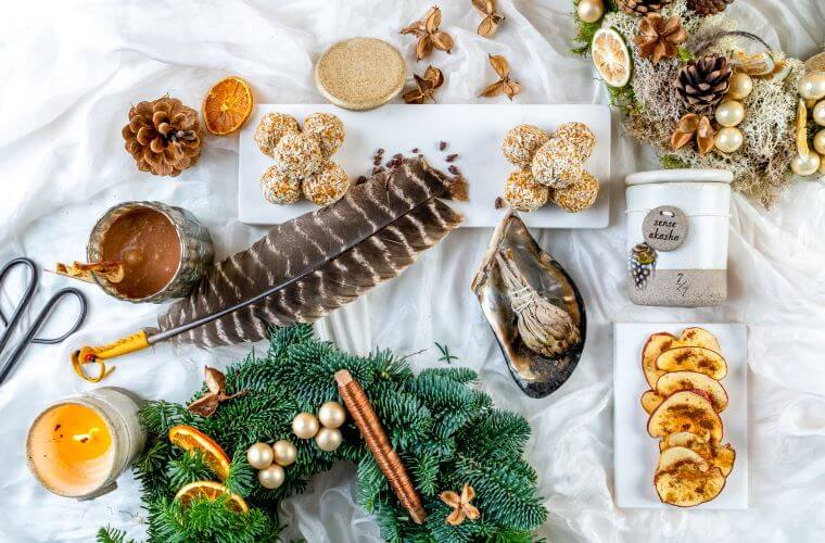 Materials for a wreath including feathers, weather cones, and dried fruit